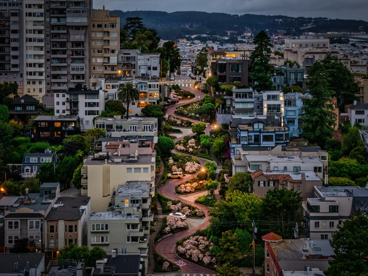 Lombard Street winding down Russian Hill in morning light, seen from above